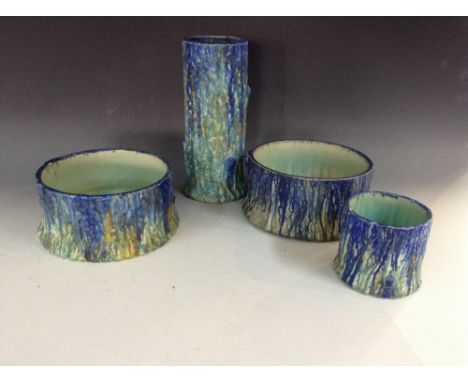 A Bretby cylindrical spill vase, of tree form, glazed in mottled tones of cobalt blue, light blue, verdigris and yellow, spre
