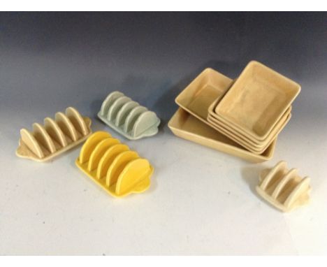 A Bretby five-bar toast rack, boldly glazed in yellow, 15cm wide, impressed marks; others, ivory and light green; another, sm