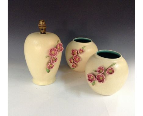 A Bretby ovoid table lamp, the cream ground applied with a naturalistically modelled sprig of pink blossom, 30cm high, c. 193