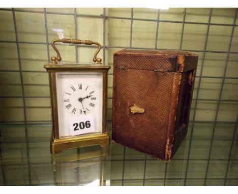 BRASS CARRIAGE CLOCK IN LEATHER CASE ENAMEL DIAL AND GLASS A/F