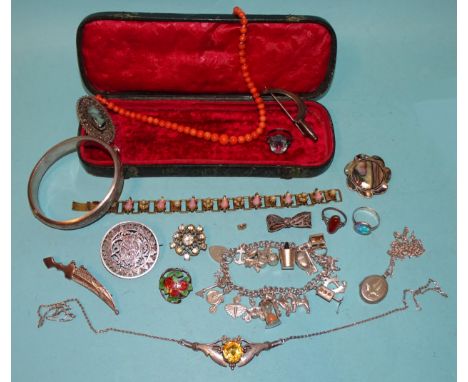 A silver hinged bangle, a white metal brooch incised with a Roman head, other silver and white metal jewellery, a coral neckl