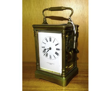A French brass carriage clock striking on a gong, retailed by Sir John Bennett Ltd, Paris, no.3872, 18cm high, (damage to dia