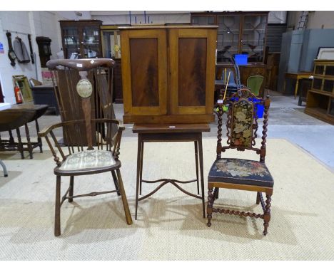 An Edwardian mahogany fold-over card table, a walnut prie deux chair, (a/f), a walnut two-door hanging cupboard and a stained