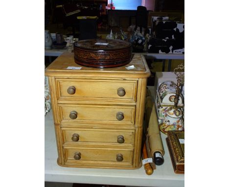 A small carved camphorwood box, 25cm wide, 13cm high, a mahogany two-division tea caddy, two nests of drawers and other woode