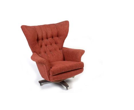 G Plan Model 6250: a 20th Century 'Blofeld' button back swivel armchair, upholstered in red fabric, raised on a four point ba