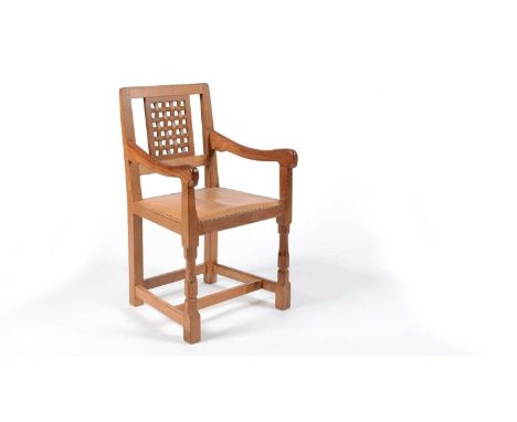 Robert 'Mouseman' Thompson of Kilburn: an oak carver chair, the lattice backrest, over a cushioned seat upholstered in tan le