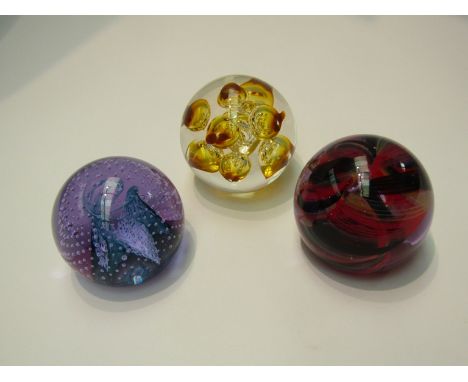 Two Caithness art glass paperweights including bubble design and an amber coloured Langham bubble glass paperweight (3)