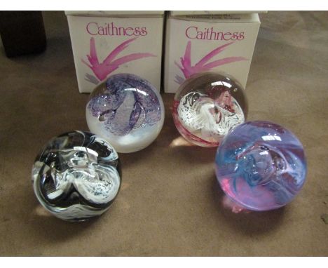 Four Caithness art glass paperweights with boxes