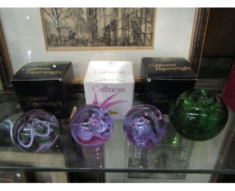 Three Caithness art glass paperweights with boxes, together with a Wedgwood apple form paperweight