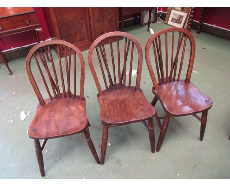a set of six elm seated stick-back chairs with ring turned legs on "H" stretcher