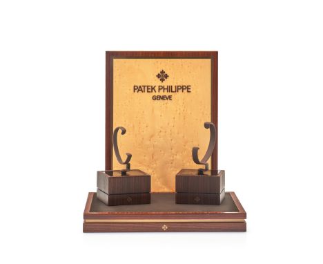 PATEK PHILIPPE SHOWROOM DISPLAY - One display in wood with Patek Philippe logo on relief, two small revolving watch display b