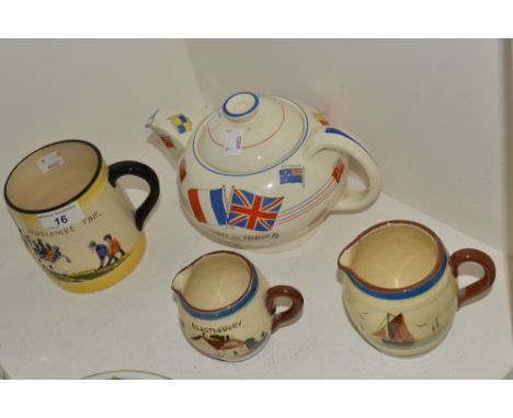 A Crown Ducal teapot, War Against Hitlerism;  Torquay jugs;  a Widecomb Fair mug;  (4)