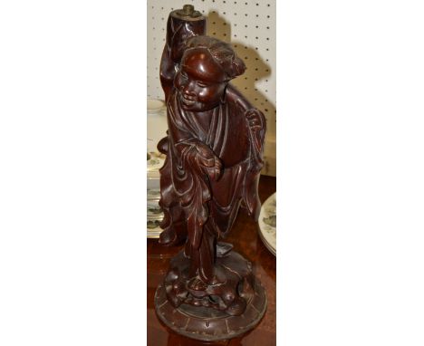 A Chinese hardwood figural lamp base, of a deity, standing, early 20th century
