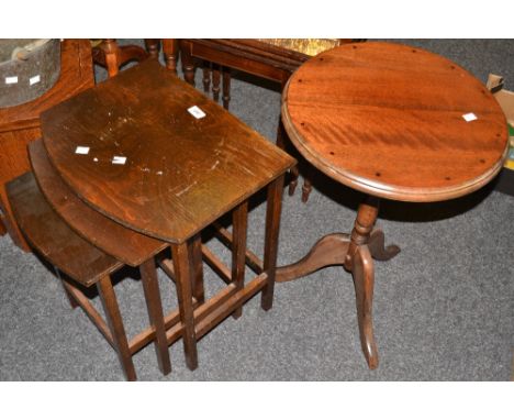 An early 20th century oak nest of three occasional tables, a  mahogany occasional table, tripod base (2)