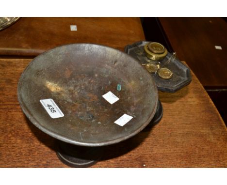 A set of cast iron kitchen scales and weights 