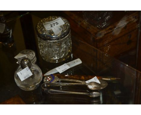 A silver topped dressing table jar;  silver sugar bows;  silver tea spoon;  etc 