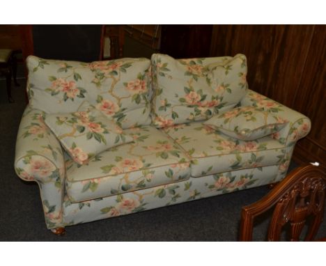 A Duresta two seater scroll arm sofa, turned legs