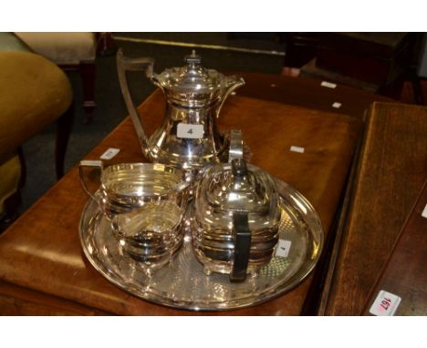 An E.P.N.S four piece boat shaped tea service; a circular engine turned tray 