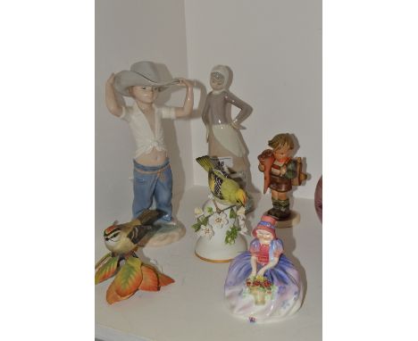 A Lladro Girl with milk pail, printed mark;  a Nao figure, of a boy wearing a hat;  a Hummel figure, School Boy;  a Royal Dou