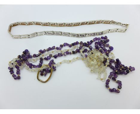 A silver necklace, an amethyst necklace and one other necklace
