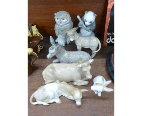 Seven Nao figures, owl, panda, two donkeys, two cows and a rabbit