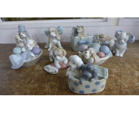 A collection of nine Nao kitten and puppy figures