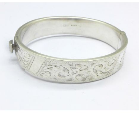 A silver embossed bangle, a/f, dented, 20g