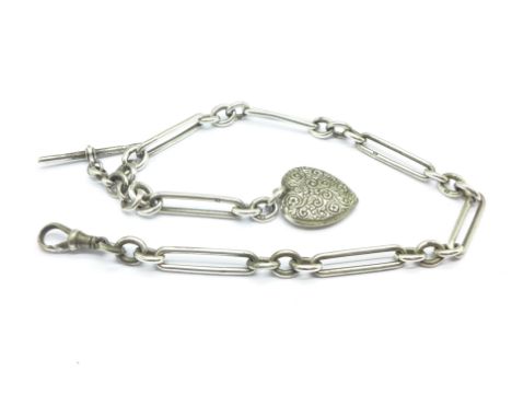 A silver watch chain with heart shaped compass fob