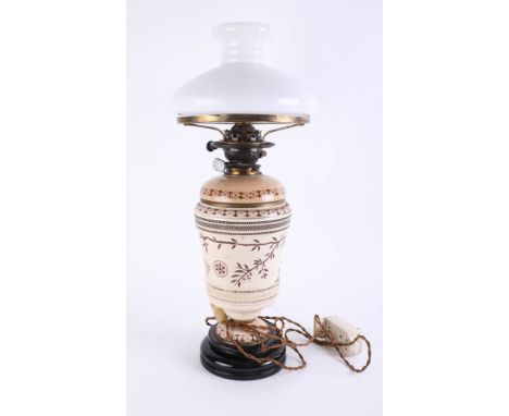 A Victorian oil lamp with opaline shade, damaged, height 60cm.
