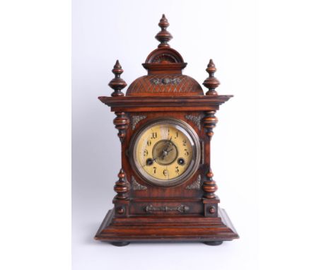 A Victorian walnut mantle clock with striking gong, with key, height 43cm.