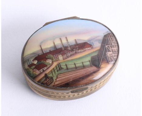 A 19th century oval pill / snuff box, set with a porcelain panel decorated with an Industrial, gilt case with glass? patterne