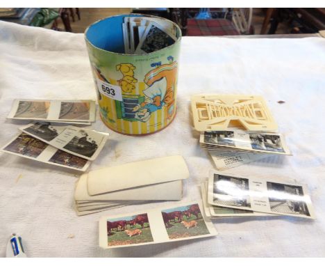 A vintage Weetabix Vistascreen stereo viewer with various stereoscope cards, in a contemporary child's tin