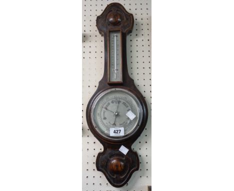 A 20th Century stained oak cased banjo barometer/thermometer with moulded decoration and aneroid works