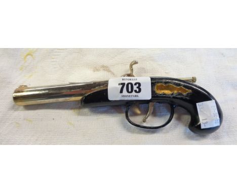 A vintage petrol lighter in the form of a pistol