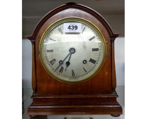 An early 20th Century polished walnut cased mitre shaped mantel clock with silvered dial and Empire eight day gong striking m