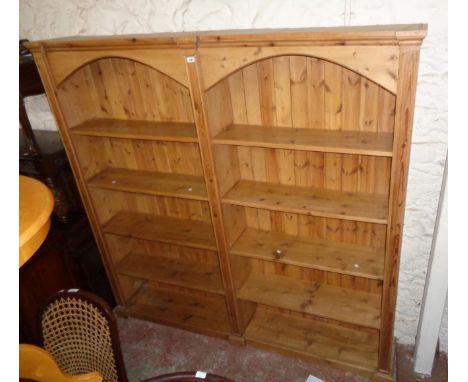 A 6' 8 1/2" 20th Century waxed pine two section side-by-side five shelf open bookcase with arcaded top and moulded decoration