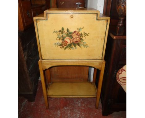 A 23" 1930`s decorative painted wood fall-front desk, set on square supports with undertier