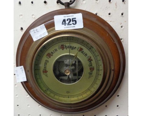 A 20th Century polished wood framed sedan style small aneroid wall barometer with visible works to dial centre