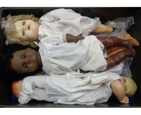 A crate containing four vintage dolls