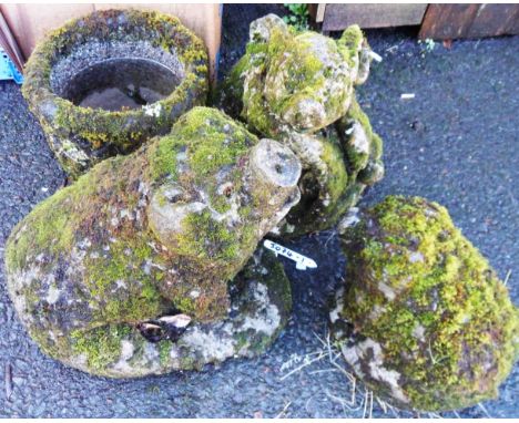 Four vintage concrete garden statues comprising three pigs and a planter
