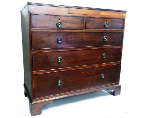 A 3' 5 1/2" late Georgian mahogany chest with secret frieze drawer over two short and three long graduated drawers, set on br