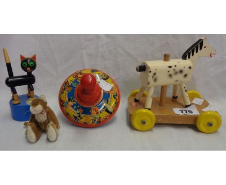 A vintage tin plate humming spinning top, two vintage wooden toys, and a felt cat