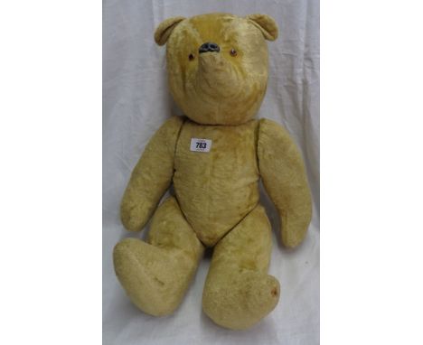 A vintage hump back Teddy bear with jointed limbs and remains of plush finish