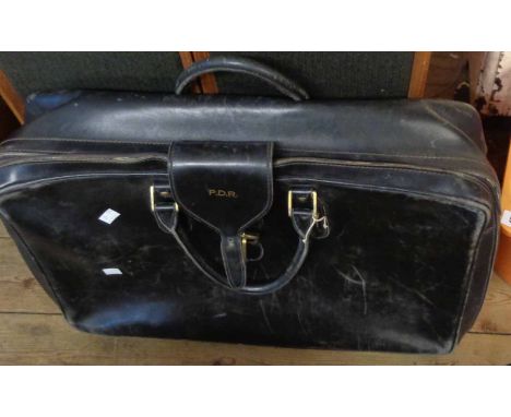 A vintage black Gucci soft leather suitcase