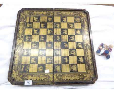 A late 19th Century Chinese lacquered papier-mâché chess, checker and backgammon board with gilt decoration - sold with dyed 