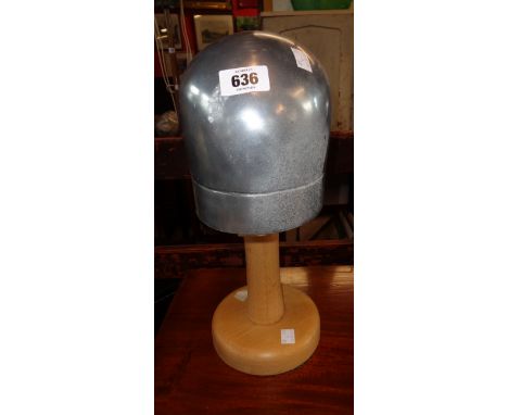 A vintage French wood and aluminium hat block