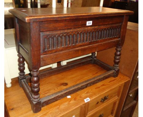 A 28 1/2" antique style oak lift-top locker chest, set on an open stretcher base with bobbin turned supports