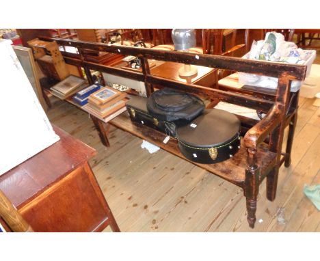 An 11" Victorian stained wood platform or waiting room bench with simple rail back, solid seat and flanking turned front supp