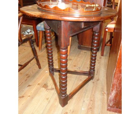 A 26" diameter polished oak table with small drawer to apron, set on triple bobbin turned supports and rail stretchers