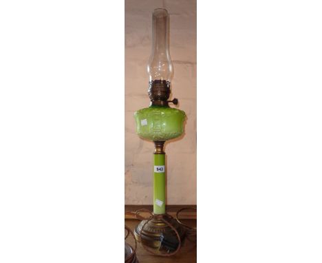 A Victorian table oil lamp with green opaque glass reservoir and stem